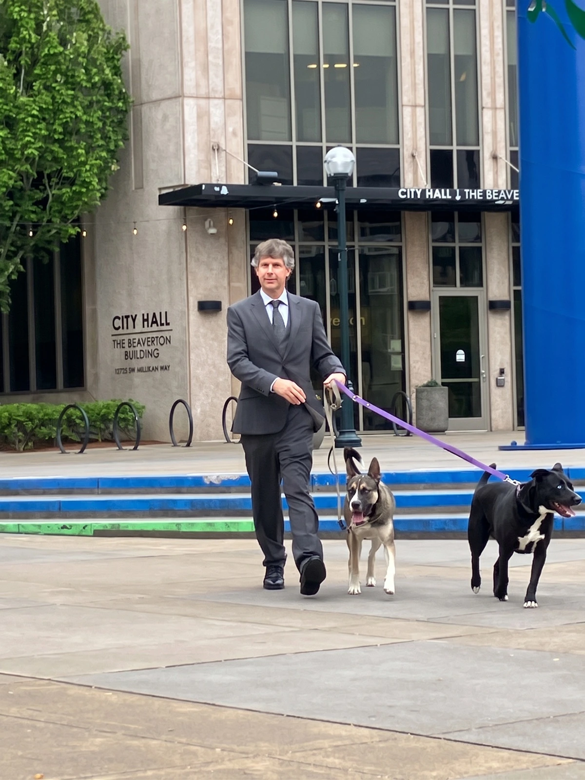 Auditor Antonio C. Pirog conducting fieldwork with Stella and Taffy outside Beaverton City Hall